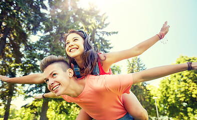 Image showing happy teenage couple having fun at summer park