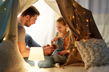 Image showing happy family playing with toy in kids tent at home