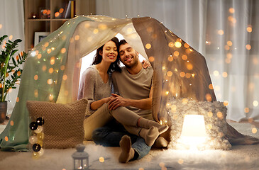 Image showing happy couple in kids tent at home