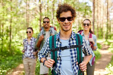 Image showing friends with backpacks on hike in forest