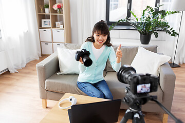 Image showing asian female blogger with camera recording video