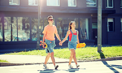 Image showing teenage couple with skateboards on city street