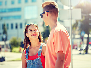 Image showing happy teenage couple looking at each other in city