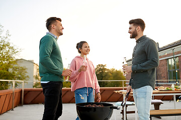 Image showing happy friends having bbq party on rooftop