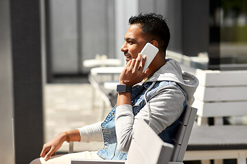 Image showing indian man calling on smartphone at street cafe