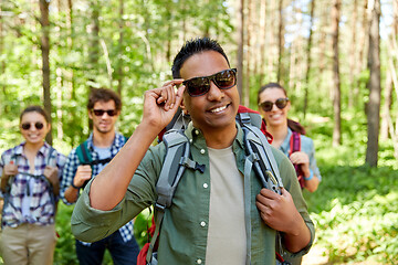 Image showing friends with backpacks on hike in forest