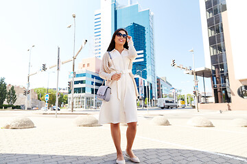 Image showing happy smiling young woman on city street