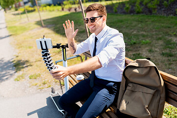 Image showing businessman taking selfie by smartphone in city