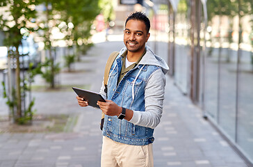 Image showing man with tablet pc and backpack on city street