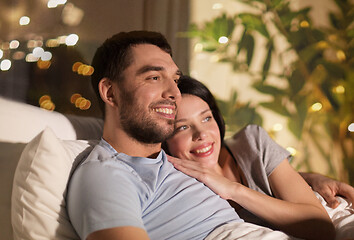 Image showing happy couple watching tv in bed at night at home