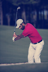 Image showing golfer hitting a sand bunker shot