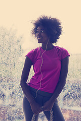 Image showing portrait of young afro american woman in gym while listening mus