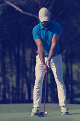 Image showing golf player hitting shot