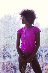 Image showing portrait of young afro american woman in gym while listening mus