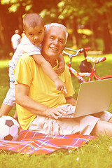 Image showing grandfather and child using laptop