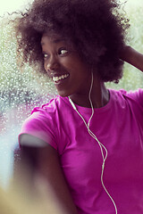 Image showing portrait of young afro american woman in gym while listening mus