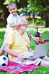 Image showing grandfather and child using laptop