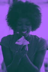 Image showing woman with afro hairstyle eating tasty pizza slice