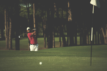 Image showing golfer hitting a sand bunker shot