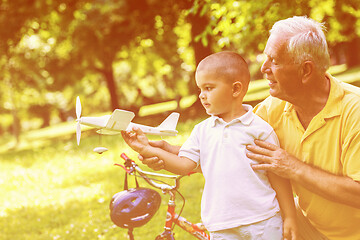 Image showing grandfather and child have fun  in park