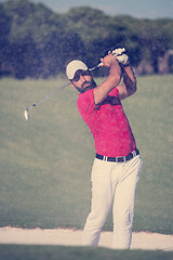 Image showing golfer hitting a sand bunker shot