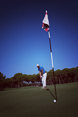 Image showing golf player hitting shot at sunny day