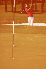 Image showing golfer hitting a sand bunker shot