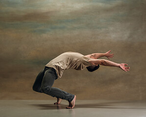 Image showing The young man dancing on gray