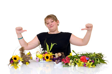 Image showing Young girl arranging flowers 