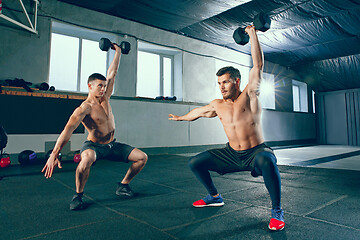 Image showing Athletic man doing exercise for arms.