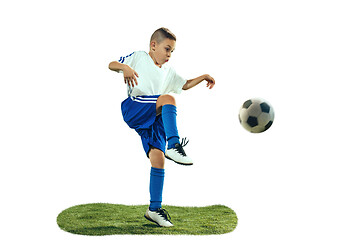 Image showing Young boy kicks the soccer ball