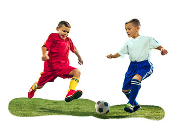 Image showing Young boys kicks the soccer ball