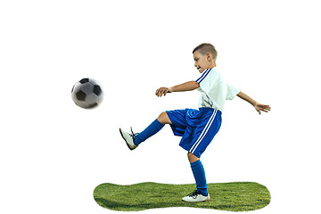 Image showing Young boy kicks the soccer ball