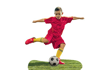 Image showing Young boy kicks the soccer ball