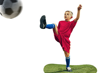 Image showing Young boy kicks the soccer ball