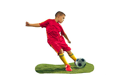 Image showing Young boy kicks the soccer ball