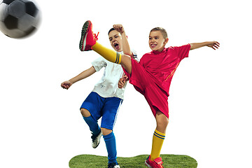 Image showing Young boys kicks the soccer ball