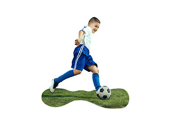 Image showing Young boy kicks the soccer ball