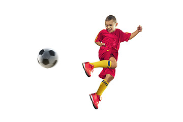 Image showing Young boy kicks the soccer ball