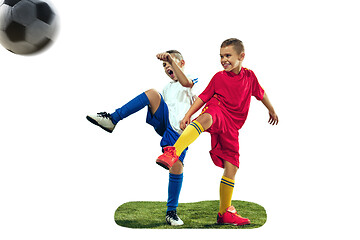 Image showing Young boys kicks the soccer ball
