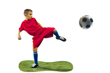 Image showing Young boy kicks the soccer ball