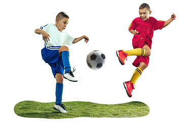 Image showing Young boys kicks the soccer ball