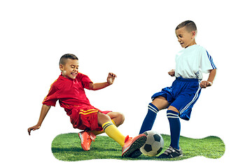 Image showing Young boys kicks the soccer ball