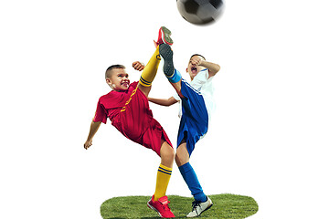 Image showing Young boys kicks the soccer ball