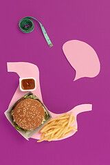 Image showing I love fast food. French fries in the form of is stomach isolated on pink background