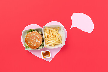 Image showing I love fast food. French fries in the form of heart isolated on red background