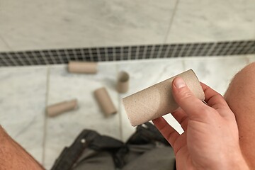 Image showing Finding empty roll in the restroom