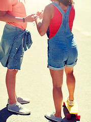 Image showing close up of teenage couple with skateboard outdoor