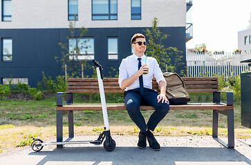 Image showing businessman with scooter drinking smoothie in city