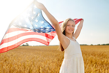 Image showing girl with american flag waving over cereal field